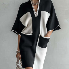 Black and white color-block midi dress with V-neck, short sleeves, and fitted knit shape