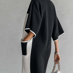 Black and white color-block midi dress with V-neck and wide short sleeves, side view