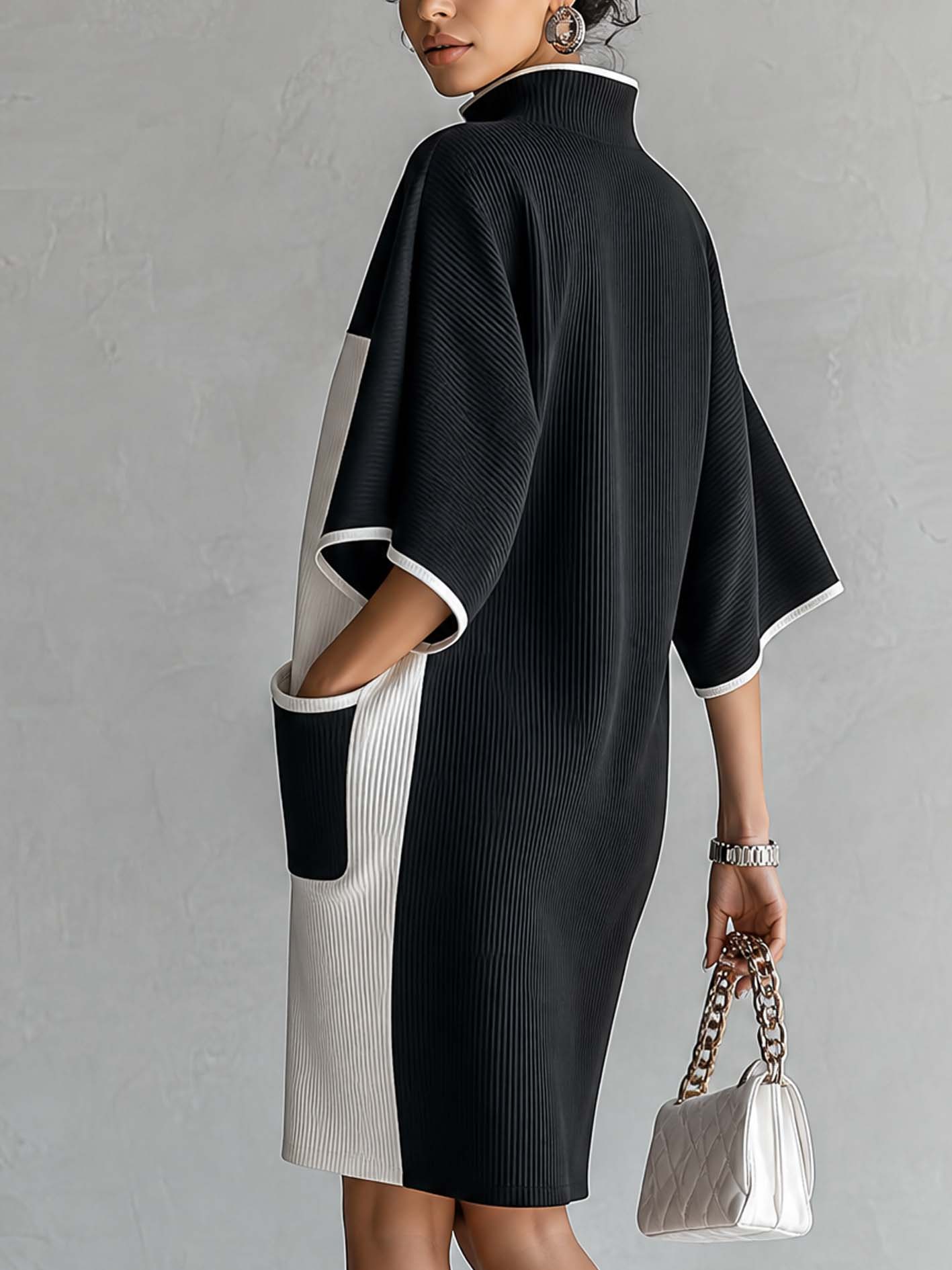 Black and white color-block midi dress with V-neck and wide short sleeves, side view