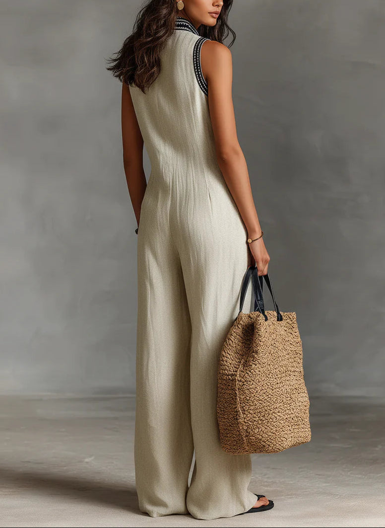 Beige sleeveless jumpsuit with high-neck zip front and wide-leg silhouette