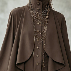 Chocolate cape-style midi dress close-up: buttoned high neck and layered cape