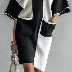 Black and white color-block midi dress with V-neck and contrast front panels, knee-length fit