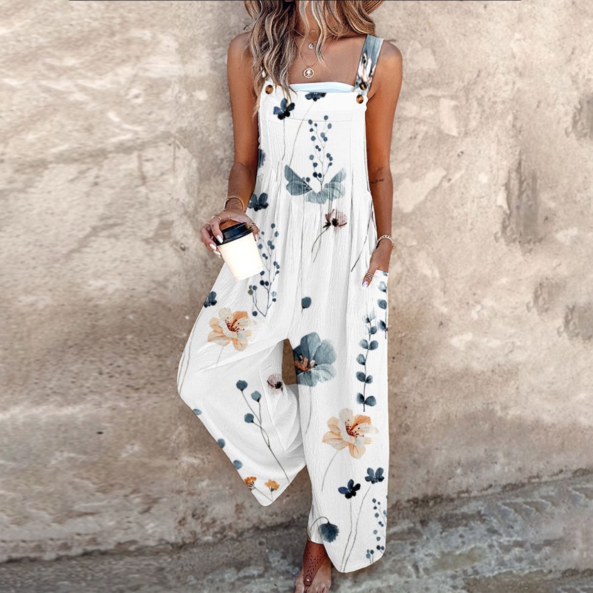 White sleeveless floral printed overalls with wide legs and botanical pattern