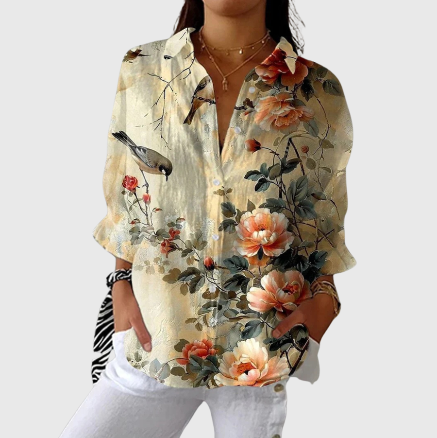 Blusa leggera beige chiaro con stampa floreale arancio e verdi, scollo a V