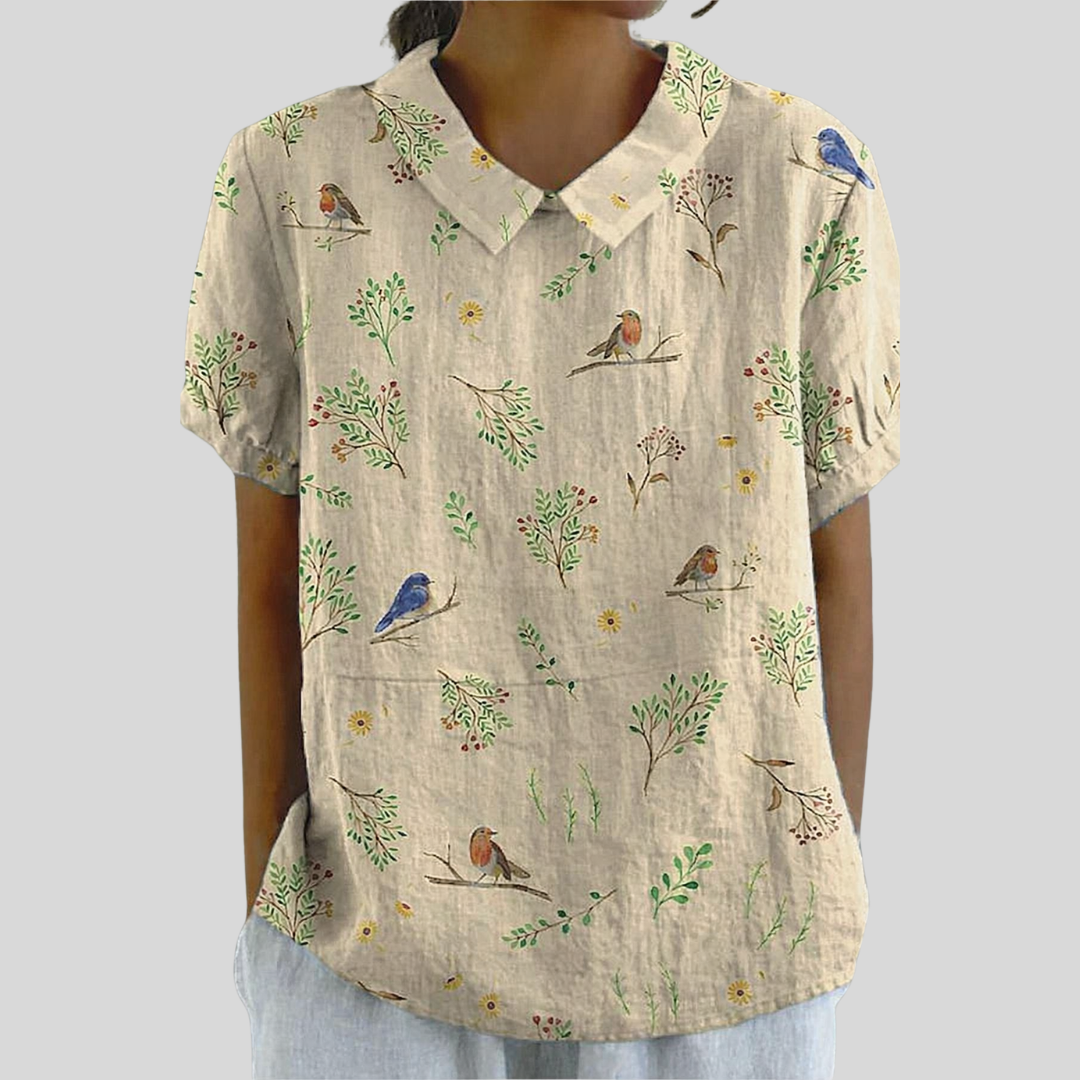 Top beige con stampa floreale e uccellini, maniche corte, scollo a V