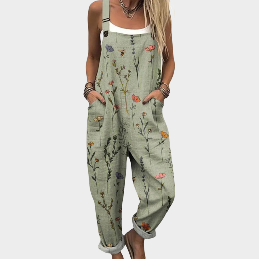 Green printed overalls with floral and insect pattern, sleeveless bib front and wide legs