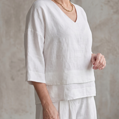 White layered V-neck top and wide-leg pants set, 3/4 sleeves and tiered hem