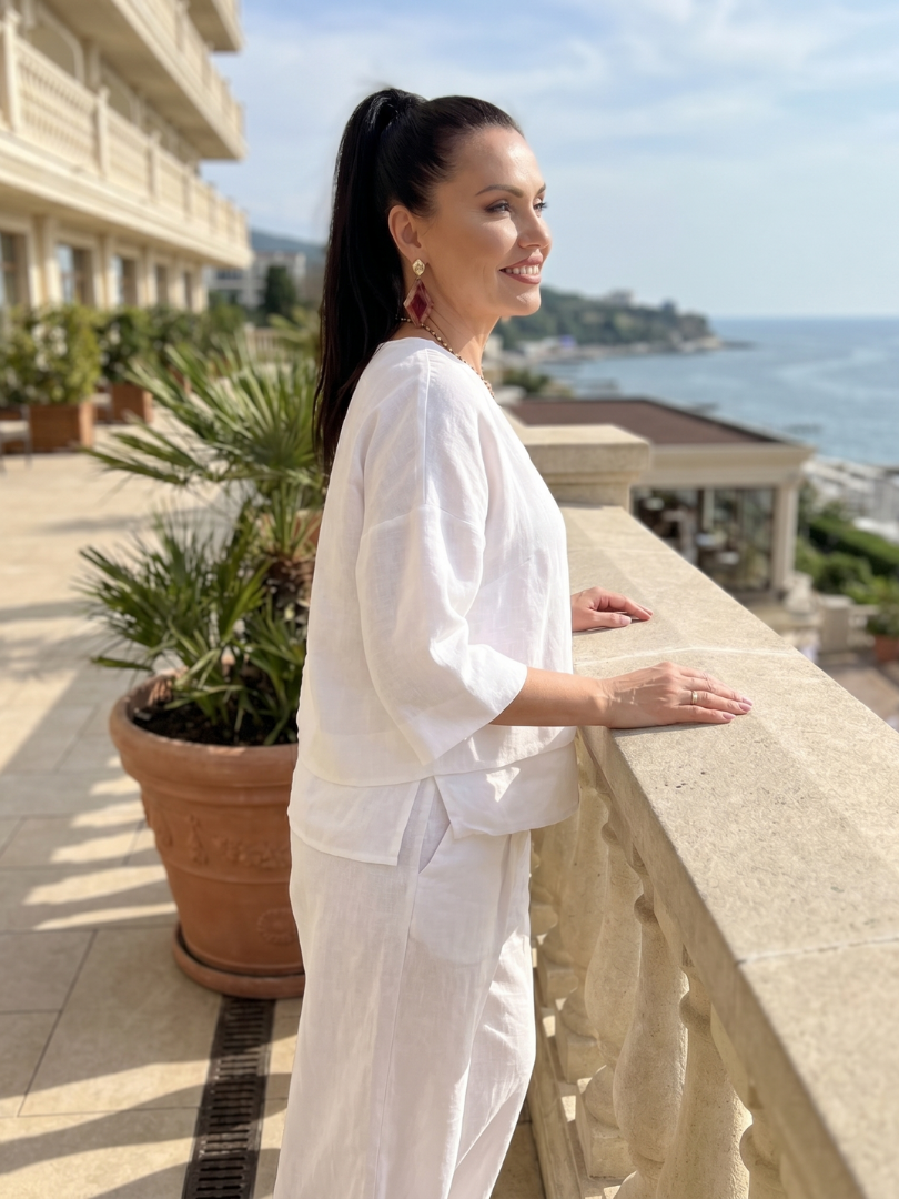 White layered V-neck top and wide-leg pants set with 3/4 sleeves
