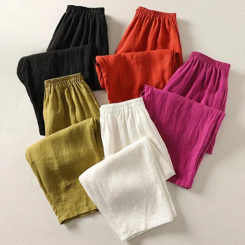 Assorted lightweight trousers with elastic waistbands in black, orange, magenta, green, and white