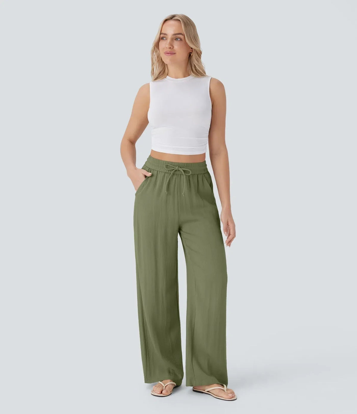 Olive green wide-leg trousers with elastic waistband and drawstring, relaxed legs.