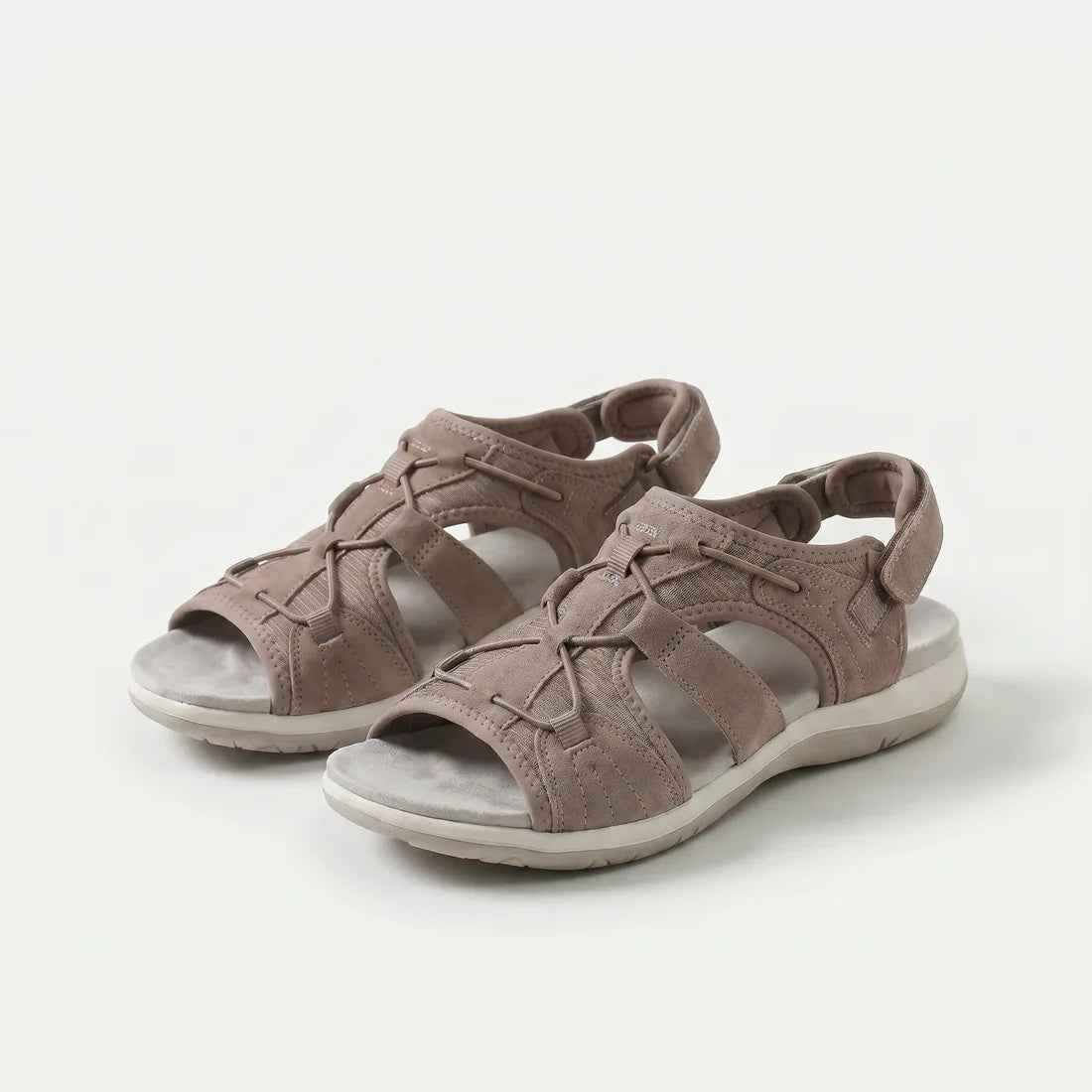 Sandali ortopedici beige con cinturini a strappo e suola ammortizzata.