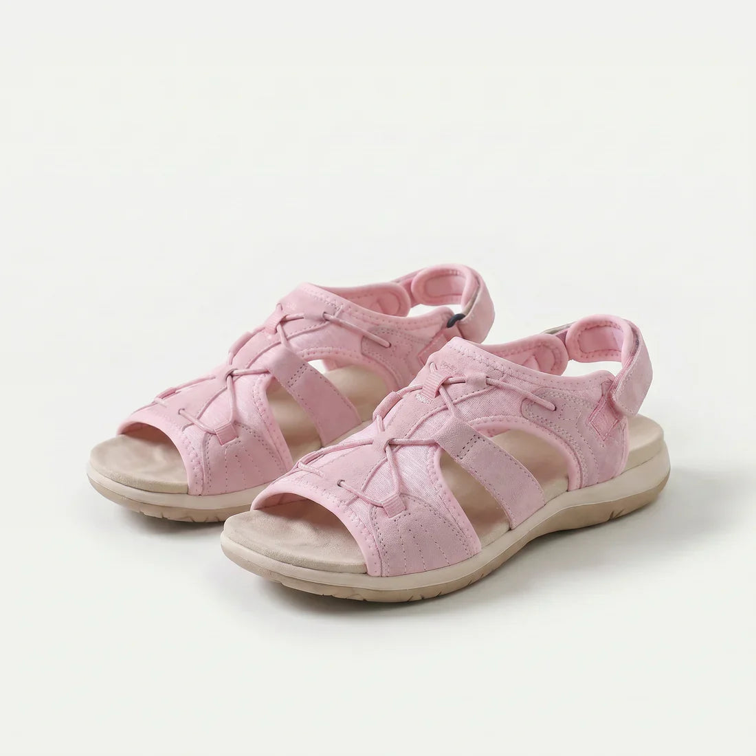 Sandali ortopedici rosa con cinturini a strappo e suola ammortizzata.