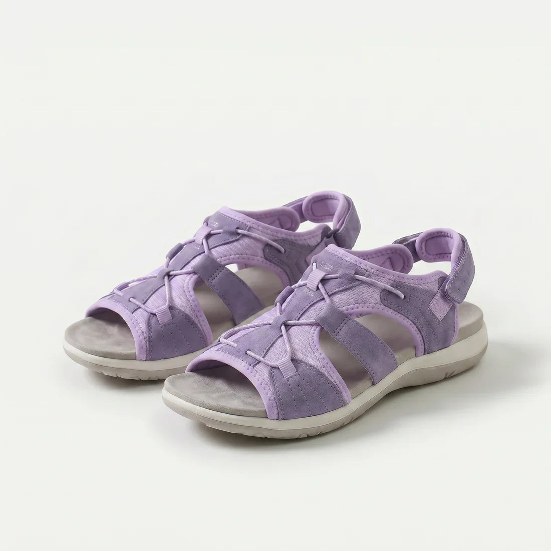 Sandali ortopedici lilla con cinturini a strappo e suola ammortizzata.