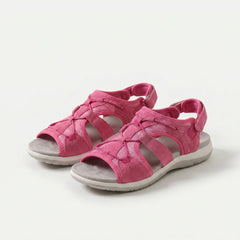 Sandali ortopedici fucsia con cinturini a strappo e suola ammortizzata.