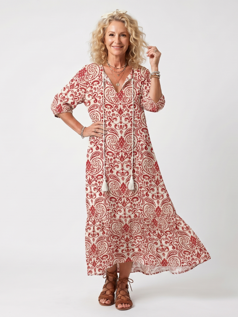 Red ornate print midi dress with tassel tie, three-quarter sleeves, and flared skirt