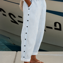 Blue-and-white striped trousers with button placket and cuffed hems