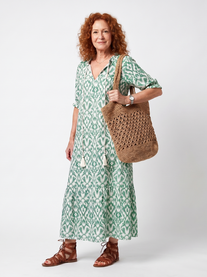 Green patterned V-neck midi dress with short sleeves and loose tiered skirt
