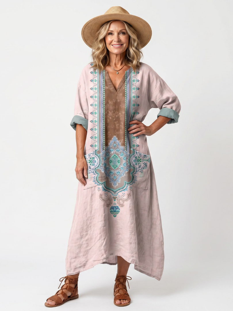 Pink embroidered midi dress with relaxed fit, side pockets, and short sleeves