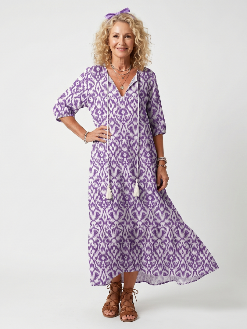 Purple printed midi dress with V-neck, tassel tie, and three-quarter puff sleeves