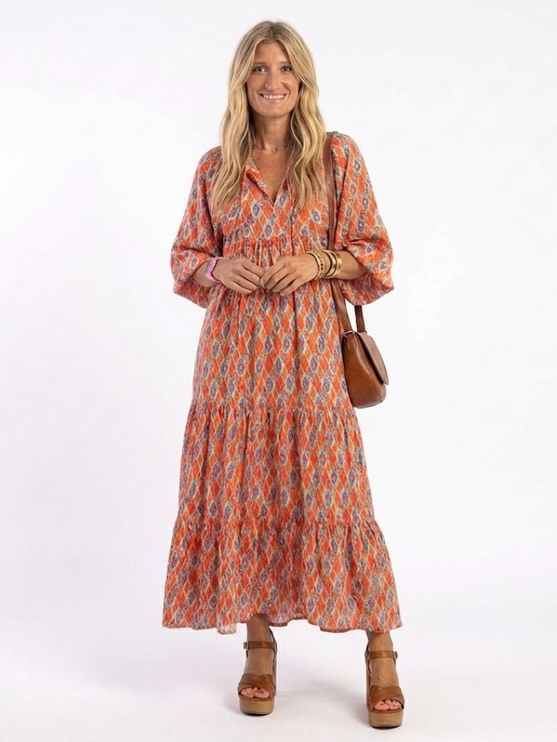 Geometric print V-neck tiered midi dress in orange with blue pattern, 3/4 sleeves