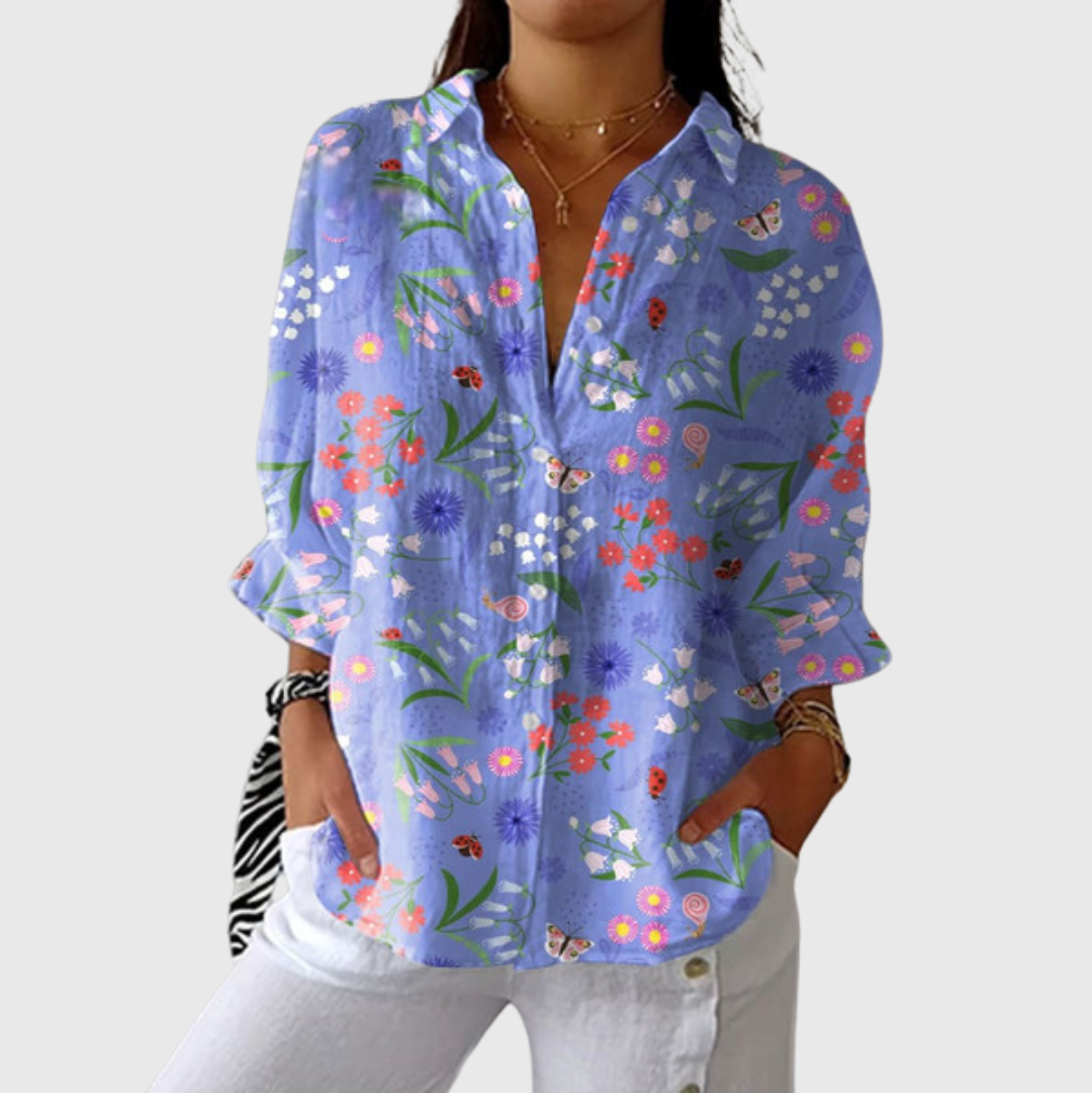 Blusa leggera viola con stampa floreale colorata, scollo a V e maniche a 3/4
