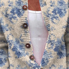 Vintage knit cardigan close-up: blue floral on cream, brown button front, long sleeve