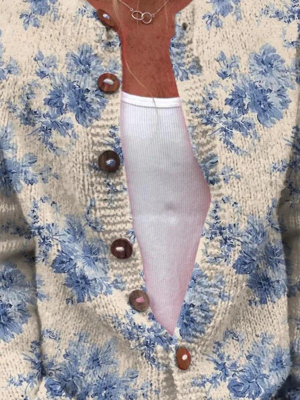 Vintage knit cardigan close-up: blue floral on cream, brown button front, long sleeve