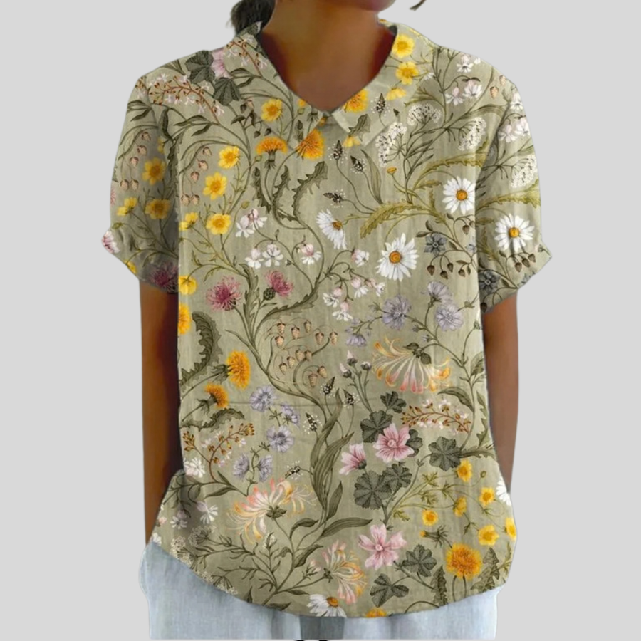 Top floreale a maniche corte, scollo a V, fondo verde chiaro con fiori colorati