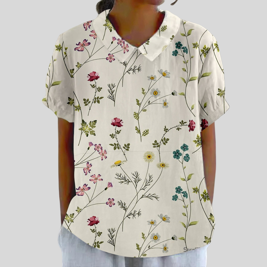 Blusa a maniche corte con colletto a bottoni, fondo chiaro e fiori multicolore