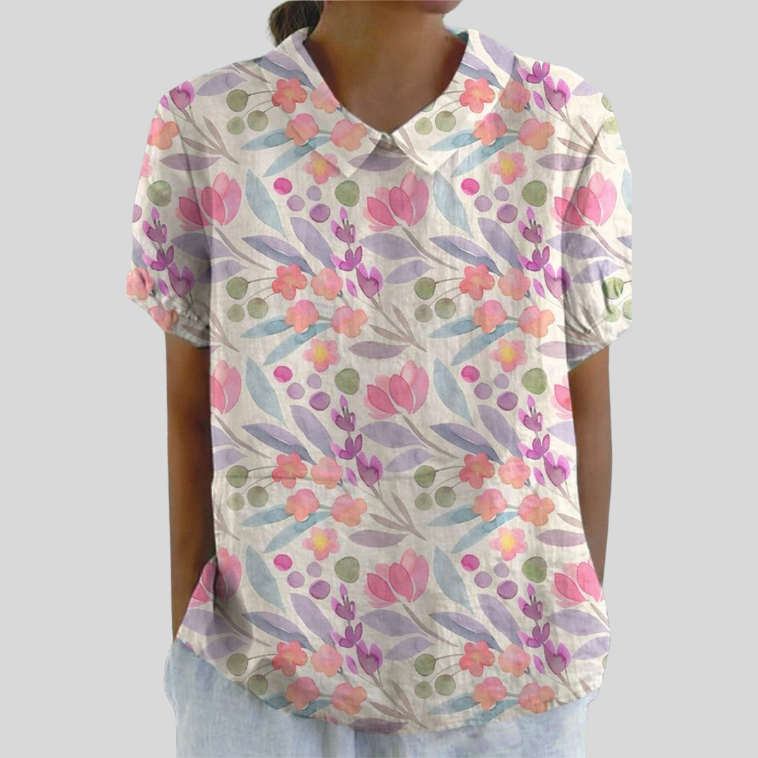 Top a maniche corte con scollo a V, fantasia floreale pastello su tessuto leggero