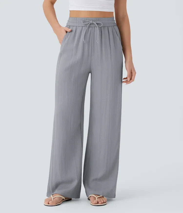 Grey wide-leg trousers with elastic waistband and drawstring ties