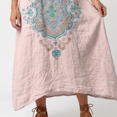 Pink midi dress close-up: turquoise embroidered center panel and neckline details