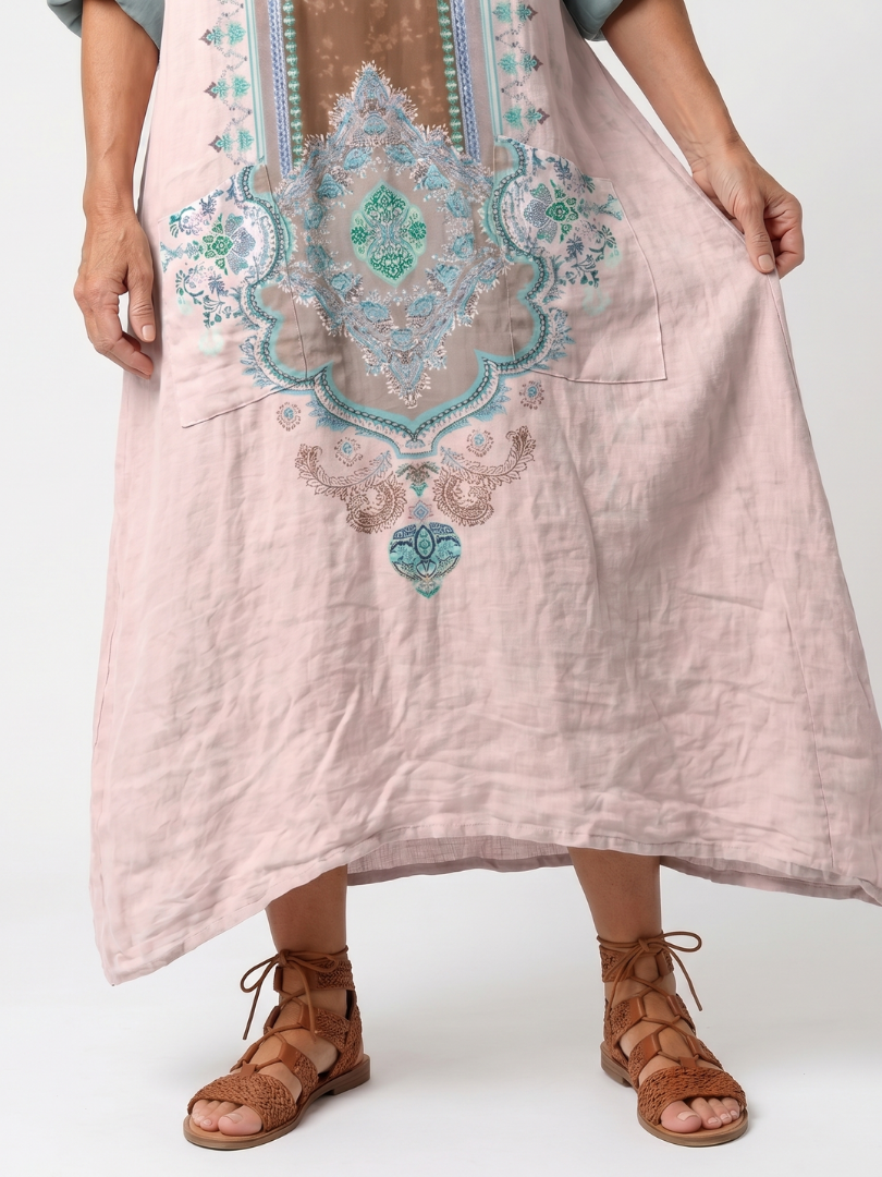 Pink midi dress close-up: turquoise embroidered center panel and neckline details