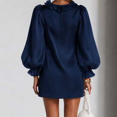 Navy satin mini dress from back view with gathered puff sleeves and pleat detail
