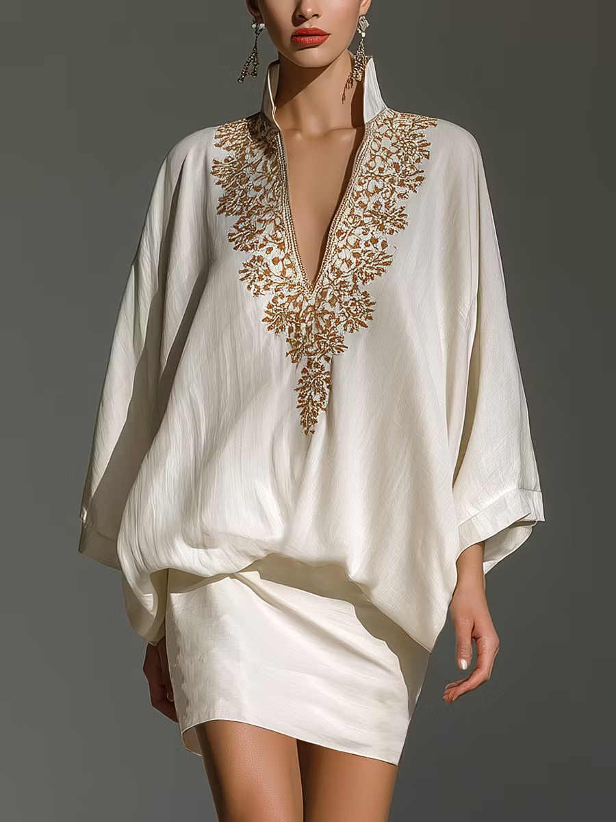 White V-neck two-piece set with gold embroidered neckline and mini skirt