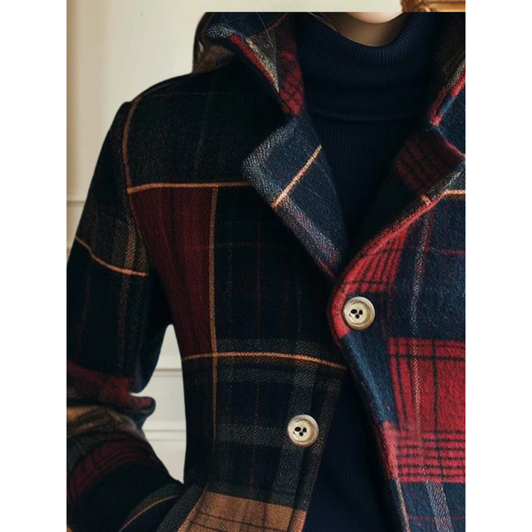 Plaid wool jacket close-up with metal buttons and red blue tartan panels.