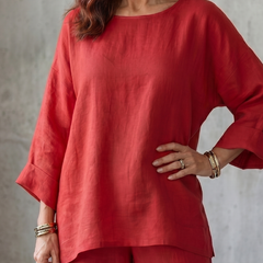 Close-up of red oversized tunic and matching wide-leg pants with cuffed sleeves