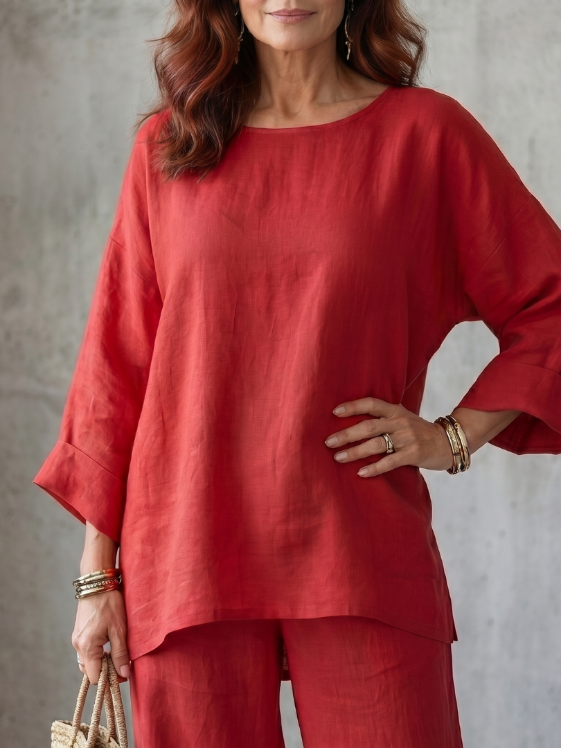 Close-up of red oversized tunic and matching wide-leg pants with cuffed sleeves