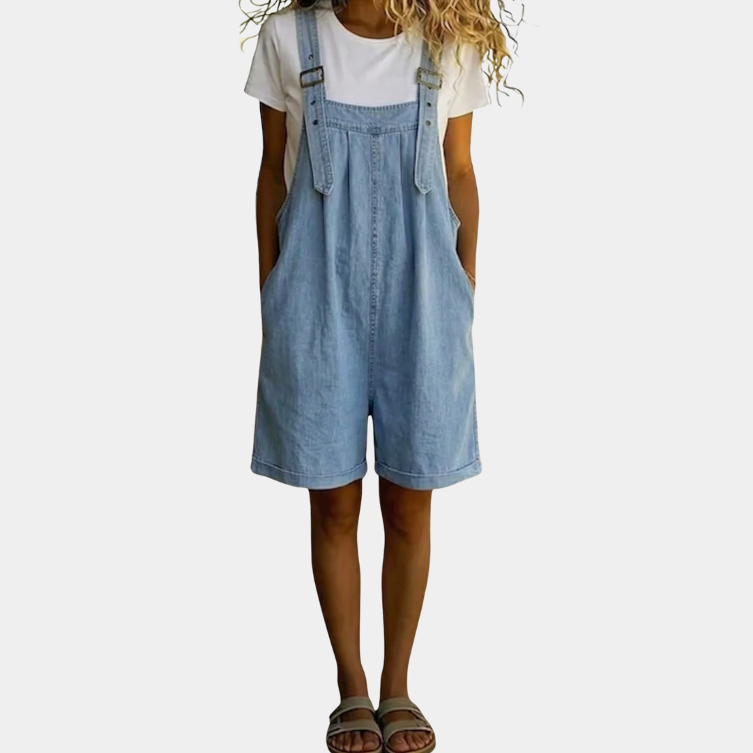 Light blue vintage-washed denim short overalls with front bib pocket and adjustable straps