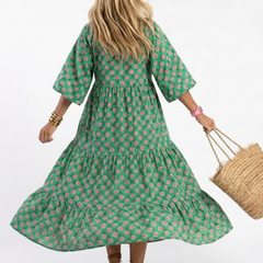 Dark green floral print tiered midi dress with V-neck and flowing skirt tiers (back view)