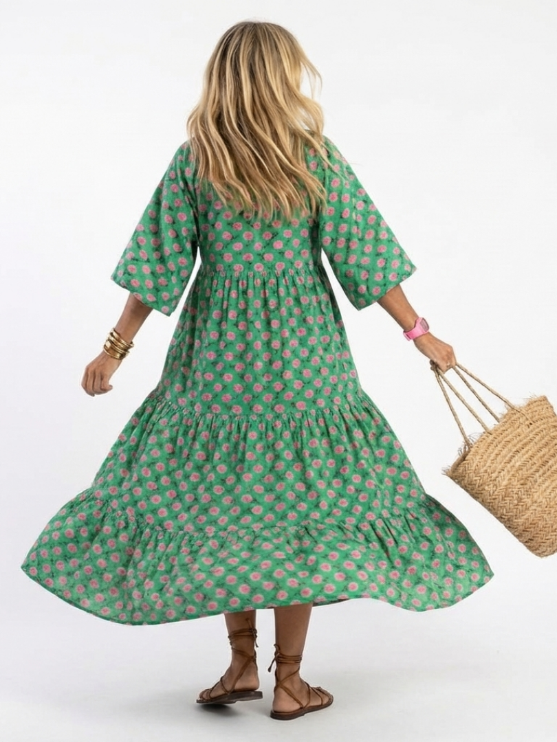 Dark green floral print tiered midi dress with V-neck and flowing skirt tiers (back view)