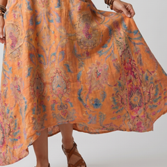 Orange printed midi dress with side pockets and flowing draped hem