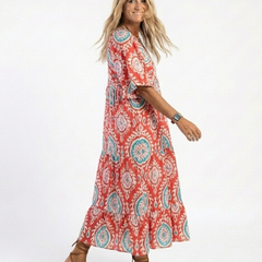 Paisley print V-neck midi dress, red with teal circular motifs, side view