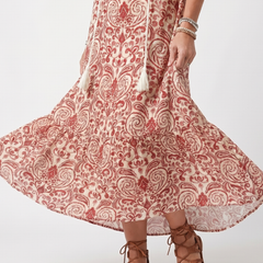 Red ornate print midi dress with full skirt flare and detailed hem, close-up