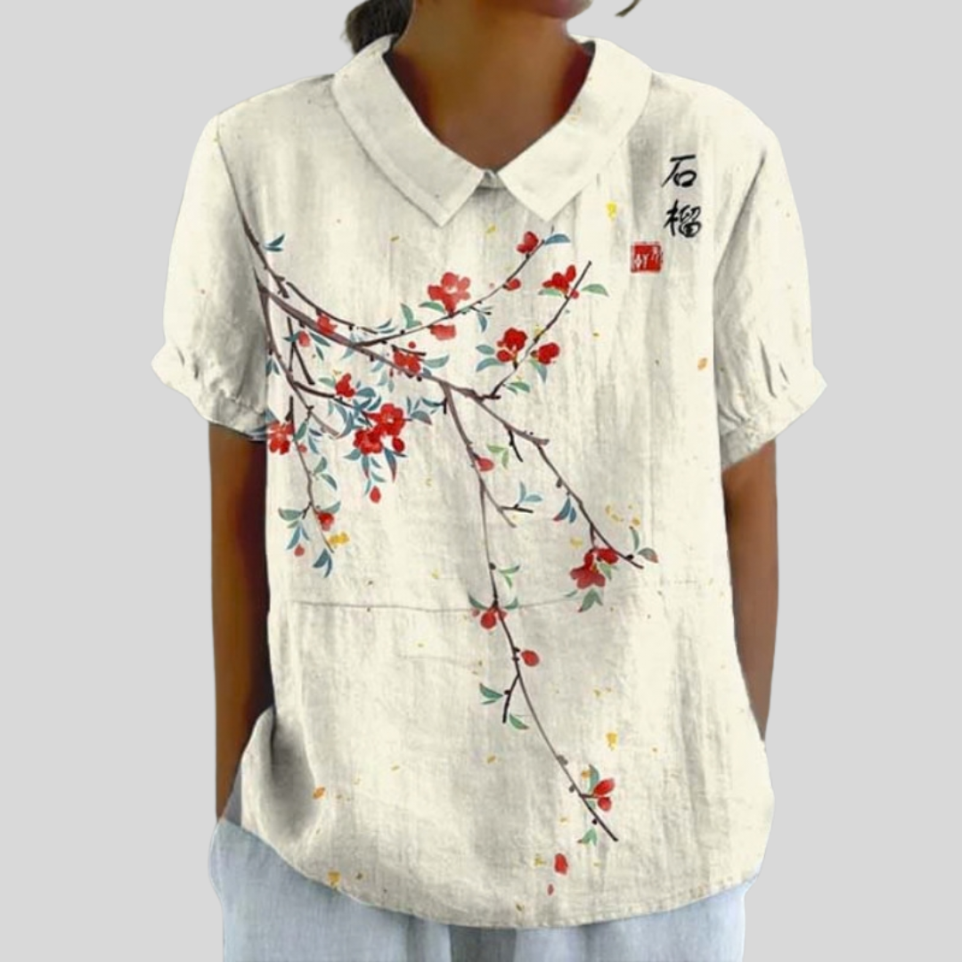 Top bianco con colletto e stampa floreale rossa e blu, maniche corte