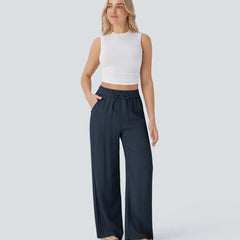Navy blue wide-leg trousers with elastic waistband and drawstring, relaxed drape.