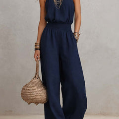 Tuta elegante blu navy senza maniche, vita arricciata e pantaloni larghi