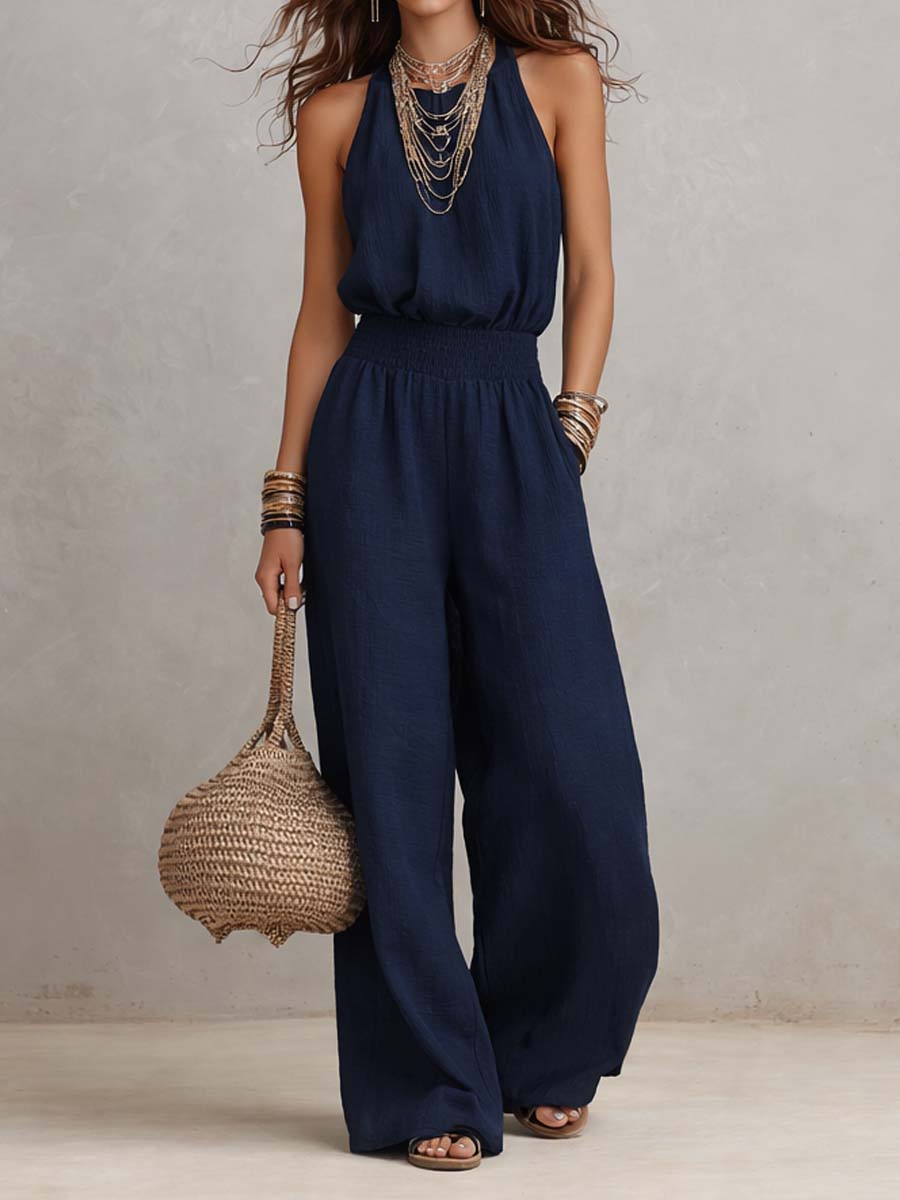 Tuta elegante blu navy senza maniche, vita arricciata e pantaloni larghi
