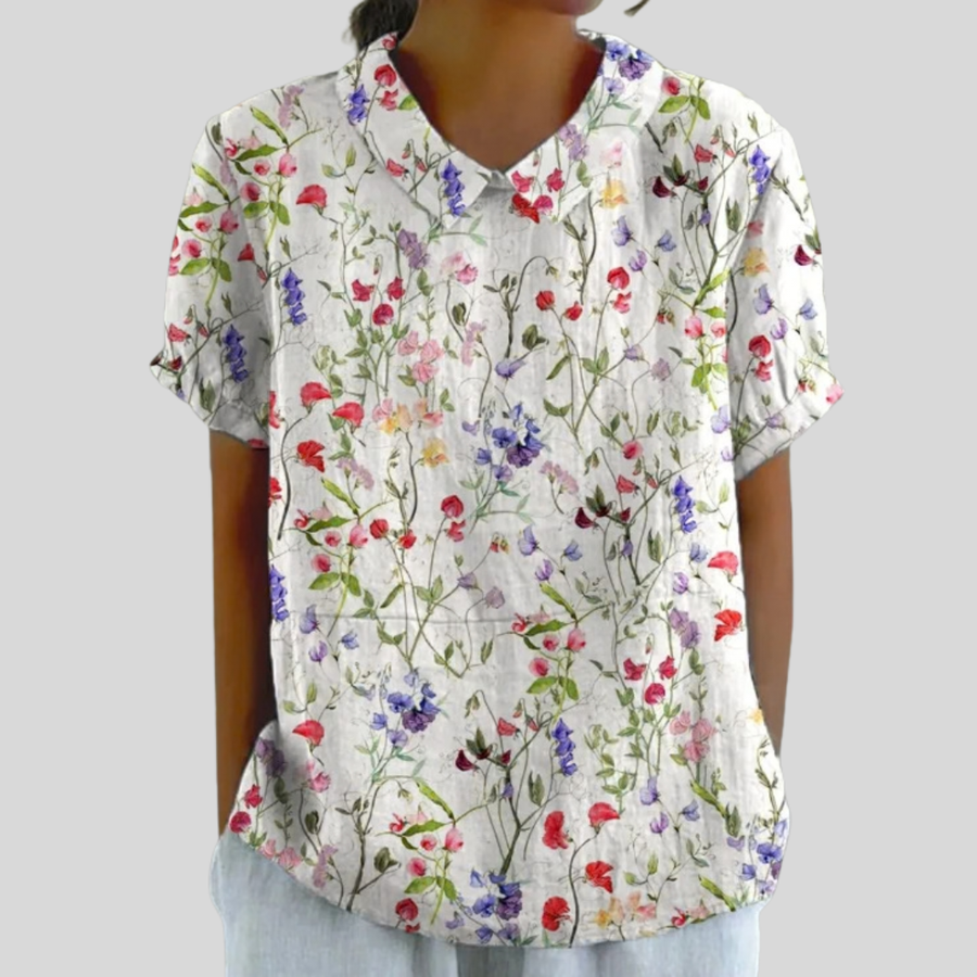 Top bianco con stampa floreale multicolore, scollo a V, maniche corte