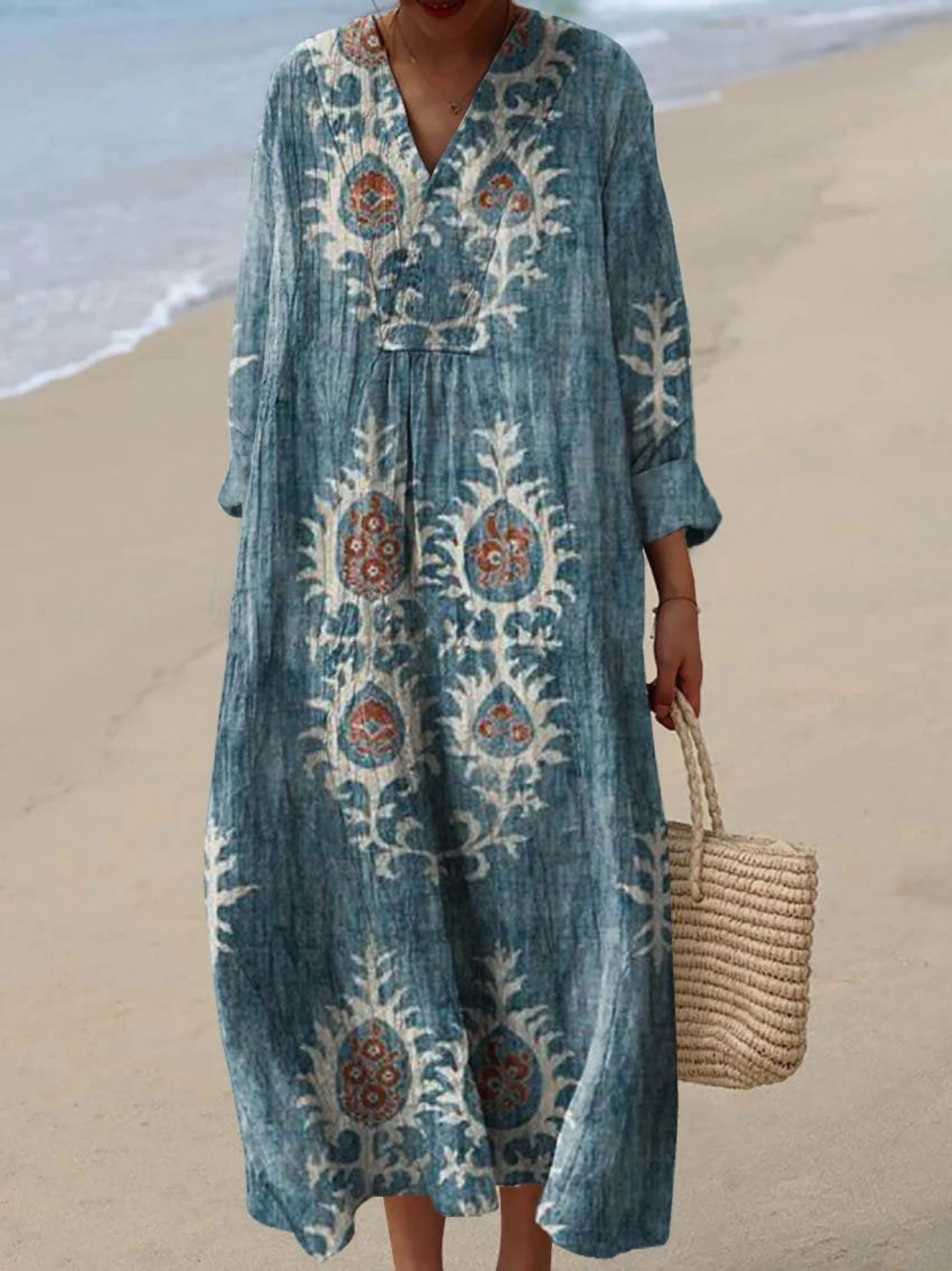 Blue boho maxi dress with colorful folk embroidery, V-neck, long sleeves, relaxed silhouette.